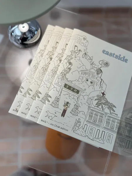 Joo Chiat photo walk cards from In Good Company with hand-drawn streetscape illustration on a brick tabletop — Singapore hidden gems