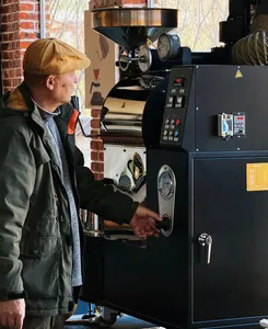 Seeker Yunnan Coffee Estate host operating a commercial coffee roaster in Lijiang, sampling and controlling roasting for specialty