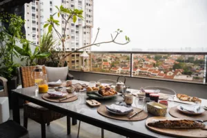 Breakfast table set on a Singapore balcony with croissants, cups and plates overlooking the city skyline — workshops in Singapore