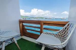 Balcony seats overlooking Labuan Bajo harbour from a Komodo boat trip cabin on a 3D2N join-in cruise