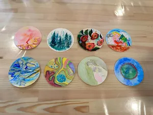 Art For Good art therapy in Singapore: circular painted artworks arranged on the studio floor during workshops in Singapore