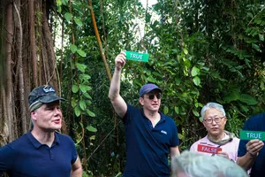 Group playing a TRUE-or-FALSE challenge in a Singapore forest during Fort Serapong discovery adventure