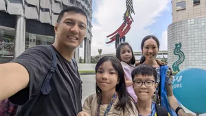 Smiling guide with children pose outdoors in Singapore during a Kampong Gelam heritage adventure, uncovering Singapore hidden gems