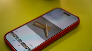 Smartphone with red case on a yellow table showing a hawker snap during Jenny Dorsey’s Hidden Hawker Stories in Singapore — Singapore hidden gems