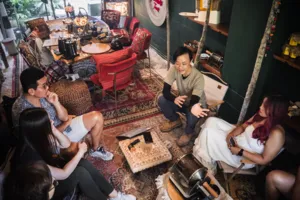 Guests gather by coffee-making equipment while an instructor explains tasting for bagel brunch in Singapore, workshops in Singapore