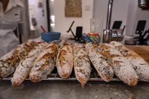 Baked French baguettes on a tray in a Singapore kitchen as part of French cooking workshops in Singapore