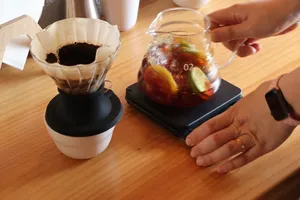 Pour-over coffee tasting at Seeker Yunnan Coffee Estate in Lijiang, with a dripper set beside a glass carafe