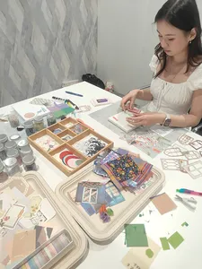 Vision-board crafting at a Gemstory workshop table as a participant assembles collage pieces for workshops in Singapore