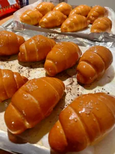 Freshly baked golden shio pan buns on a tray, made for a The Daily Staples workshop in Singapore today
