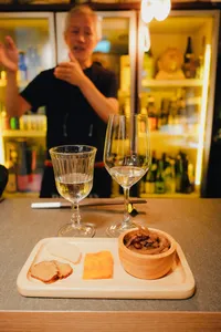 Sake tasting in a tucked-away Singapore shop with host SakeMama explaining pours over small plates, Singapore hidden gems