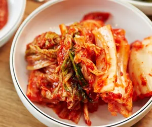 Close-up kimchi Korea yang baru dibuat di dalam mangkuk daripada pengalaman menjamu selera sambil membuat kimchi bersama cef Korea di Singapura