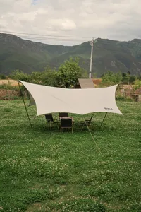 White shade sail over chairs in the Seeker Yunnan Coffee Estate garden, overlooking mountains near Lijiang in Yunnan