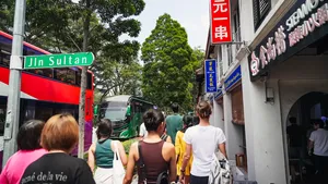 People strolling past hawker storefronts along Jln Sultan, Singapore on Jenny Dorsey’s Hidden Hawker Stories — Singapore hidden gems