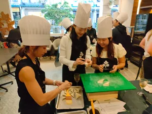 Team members in chef hats work at green prep boards for the Local Produce Cooking Challenge in Singapore, workshops in Singapore
