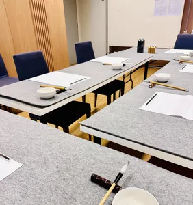 Prepared calligraphy desks with paper, brushes, and cups for practising Chinese brush writing in Singapore—workshops in Singapore