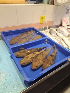 Whole fish in blue plastic crates in a Singapore fish market stop on the Pasar Fish Chinatown Cantonese tour