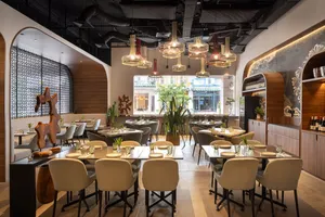 Set dining tables in Coriander Leaf’s Singapore venue for teams at local produce cooking challenge workshops in Singapore