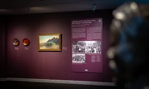 Framed Vietnamese artworks and wall information panels inside Quang San Art Museum in Ho Chi Minh City during an art tour