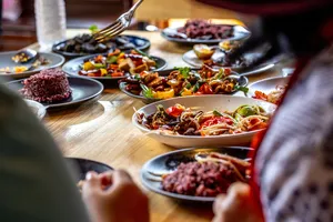 Forage-to-table feast at a Mae Kampong cooking class in Chiang Mai, with colourful plated dishes laid out on a wooden table