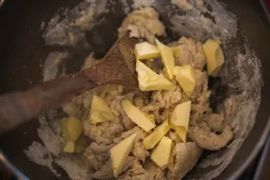Butter cubes melting into a dough mixture in a cooking pot, showing part of a croissant bake in Singapore — workshops in Singapore