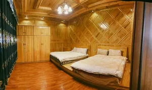 Wooden guest room with two beds at a Tibetan family homestay in Shangri-La on a Khampa Caravan 2D2N stay