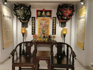 Ho Chi Minh City Chinatown lion-dance heritage room display with ornate lion heads, festive banners and a ceremonial altar