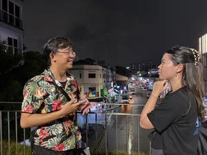 Indie Singapore Tours guide chatting with a traveller during a private night walk through Geylang, Singapore; Singapore hidden gems