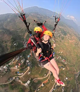 Tandem paragliding flight with Sapa Paragliding over Vietnam’s terraced valleys beneath the wing from above, Sapa