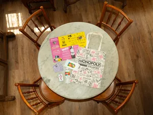 Monopoly Hidden Singapore game cards and clue sheets on a marble table in Katong-Joo Chiat, Singapore, to uncover Singapore hidden gems