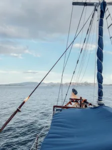 Sailing on a Deluxe Phinisi with ropes and sail rigging against open ocean during a shared Komodo cruise, Komodo Island