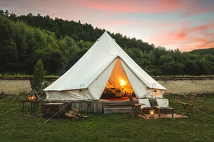 White canvas tent lit by lanterns during a 2D2N Tibetan mountain valley stay with Caravan Treks by Ferme Liotard in Shangri-La