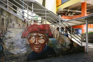 Street mural in Singapore Chinatown alley under a covered walkway, featuring a painted portrait as your team explores Singapore hidden gems