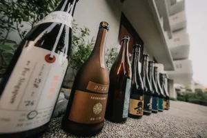 Line of labelled sake bottles for a rare Singapore tasting, housed along a corridor display in a tucked-away shop
