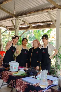 Indigenous Sabahan cooking with a local family in Kota Kinabalu, Borneo—four hosts posing at a covered food station