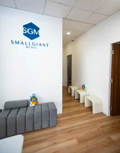 SmallGiant Music studio lounge in Singapore with SGM logo and seating areas for composing soundtracks during workshops in Singapore