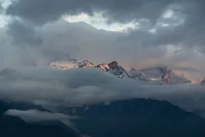 Meili Snow Mountain sunrise over the cloud-filled peaks during a 2D2N trek from Shangri-La, Yunnan