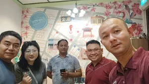 Group smiling indoors in a shop during a real-life Monopoly team route in Katong-Joo Chiat, Singapore hidden gems