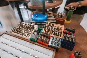 Tray of metal ring inserts and stamp tools on a worktable at Fat Anvil Studios in Singapore, workshops in Singapore