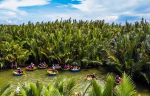 Kayaks on a calm palm-lined river with dense mangrove forest, viewed from above during a Ho Chi Minh City water transport ride