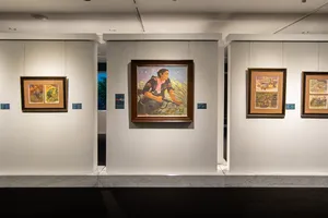 Framed paintings line white walls of Quang San Art Museum in Ho Chi Minh City, arranged for a guided Vietnamese art tour