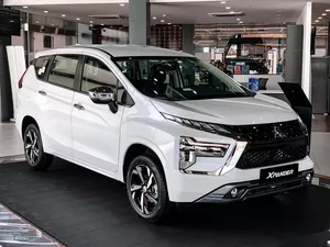 White Mitsubishi Xpander MPV displayed in a showroom, Ho Chi Minh City transport option for renting or buying