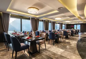 Elegant 5-star breakfast dining area on Doris Cruise with neatly arranged tables and large sea-view windows in Halong Bay