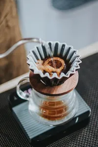 Brewed pour-over coffee dripping into a carafe during a Bali Beans coffee experience at their Kintamani farm, Bali