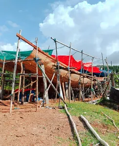 Boatside wooden vessel with red sail awning during a hidden mangroves and village visit day trip, Labuan Bajo