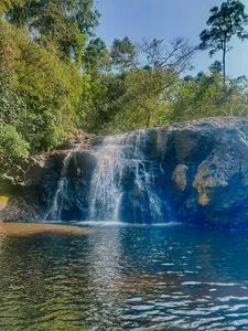 Waterfall cascading into a pool amid lush forest in Khao Yai National Park for wildlife trekking days