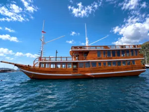 Wooden phinisi cruise boat sailing on open water during a 3D2N shared Komodo voyage from Labuan Bajo, Komodo Island