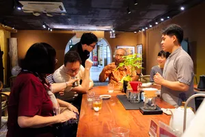 Guests learning about rare agarwood scent at a host-led tasting table in Hanoi, Vietnam, during an Up Travel Vietnam tour