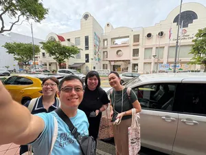 Friends posing on a street outside the community club during a real-life Monopoly game in Katong-Joo Chiat, for team building Singapore