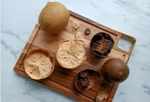 Wooden tray of TCM mocktail ingredients: dried mushrooms, roots and citrus slices during workshops in Singapore