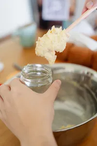 Hands lifting fluffy shio pan and spreading flavoured butter during a bread-making class—workshops in Singapore